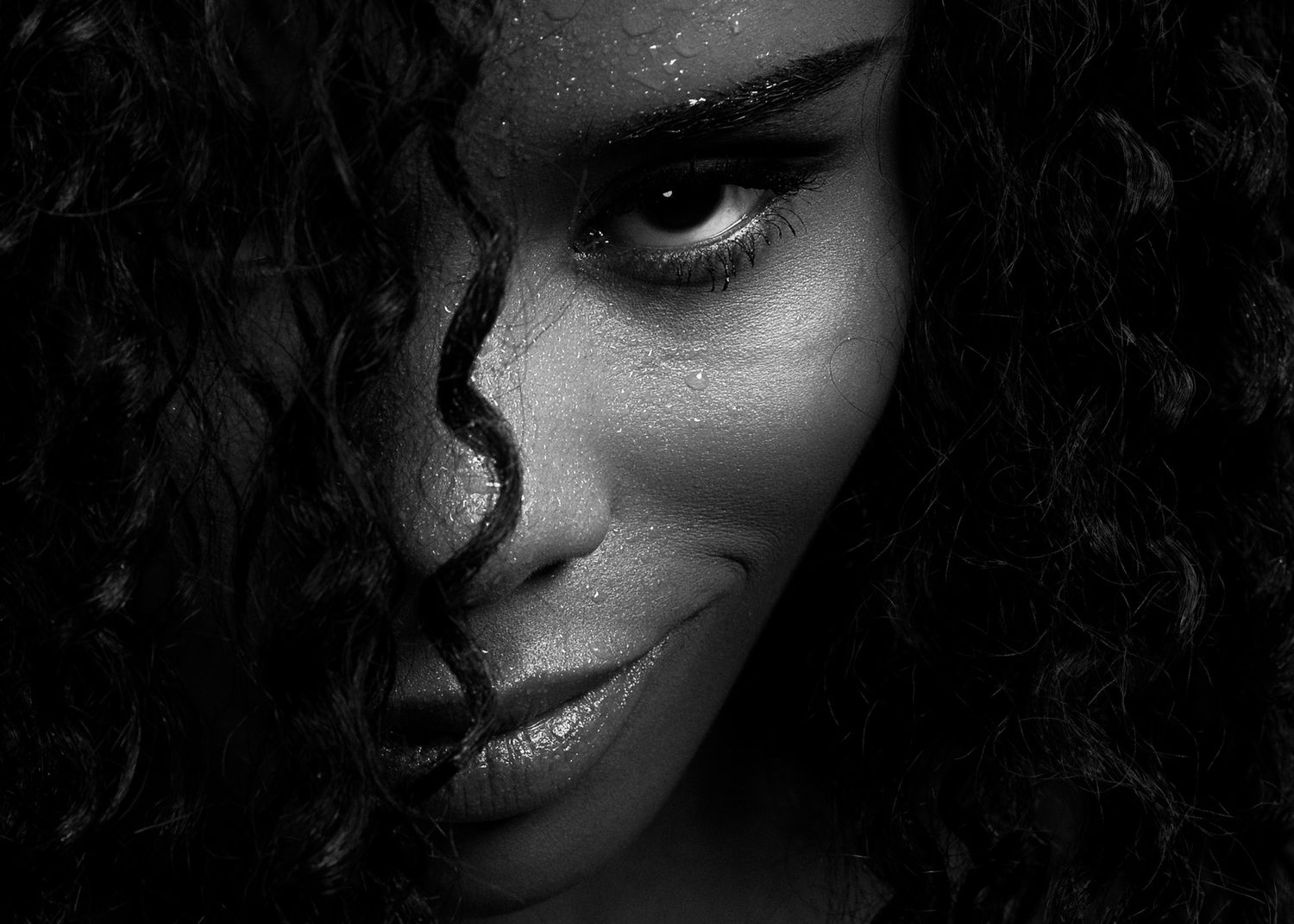 Close-up black and white portrait series featuring dramatic lighting and shadows.