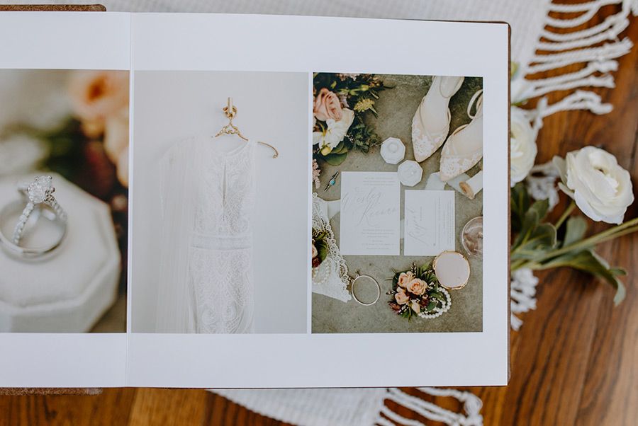 Wedding details including a white gown, floral arrangements, and rings captured in multiple frames on a wooden surface.