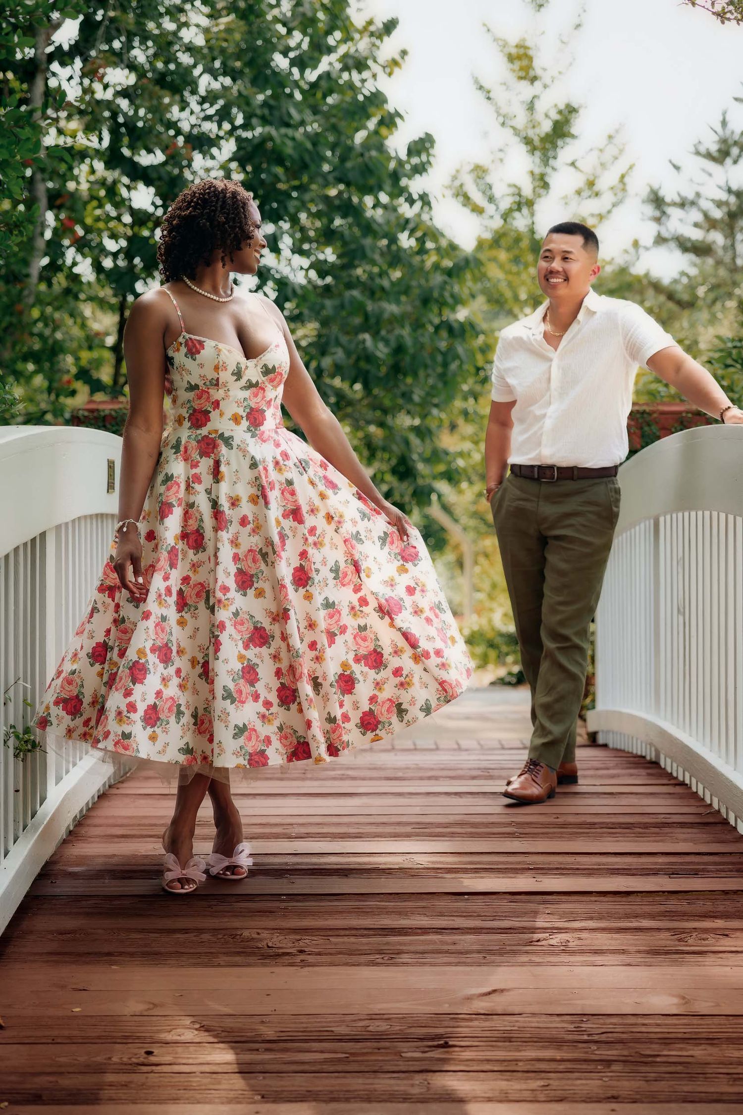 A sequence of photos showing two people dancing playfully on a wooden bridge surrounded by green trees.