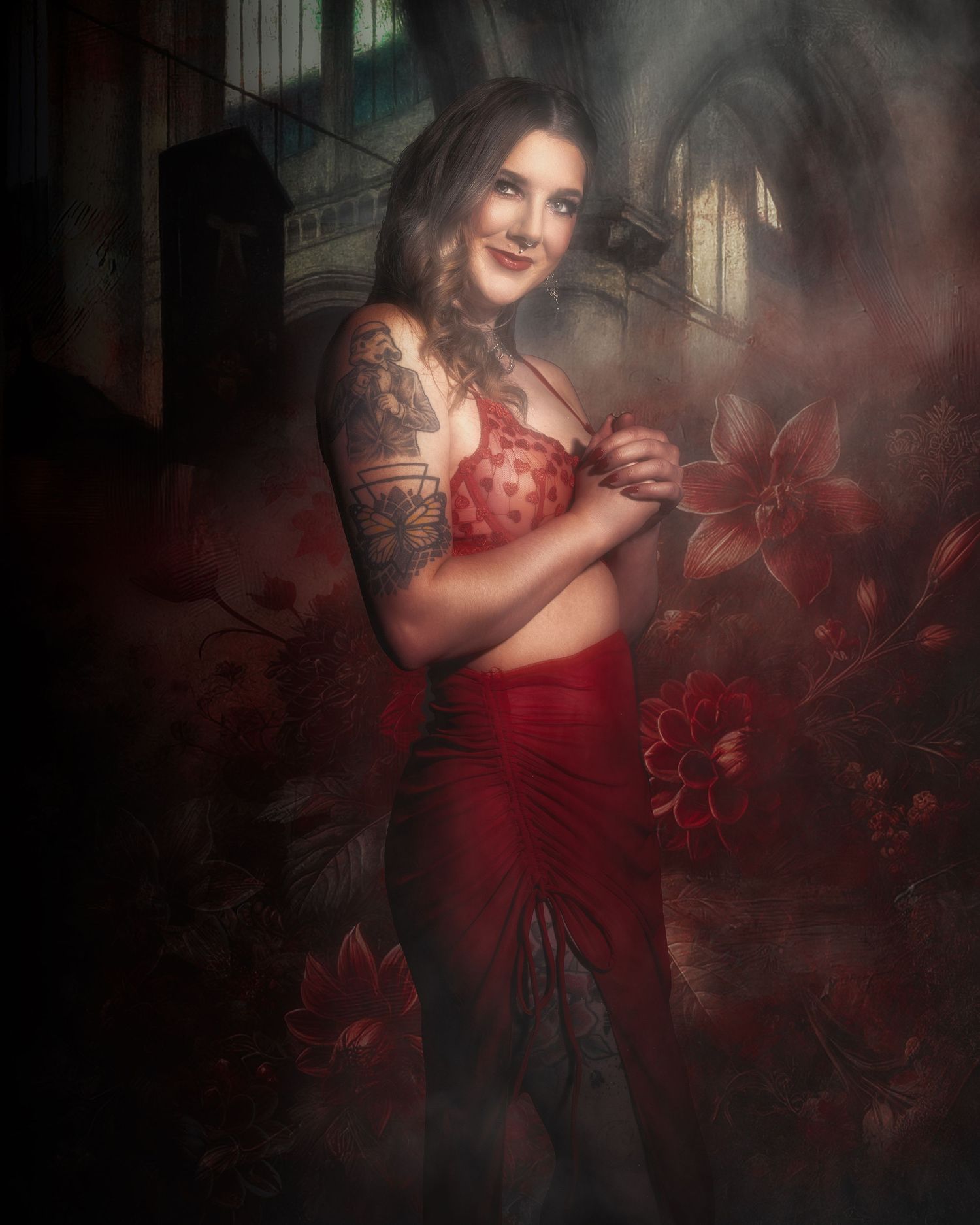 Artistic portrait in red and burgundy tones with dreamy floral elements and moody lighting.