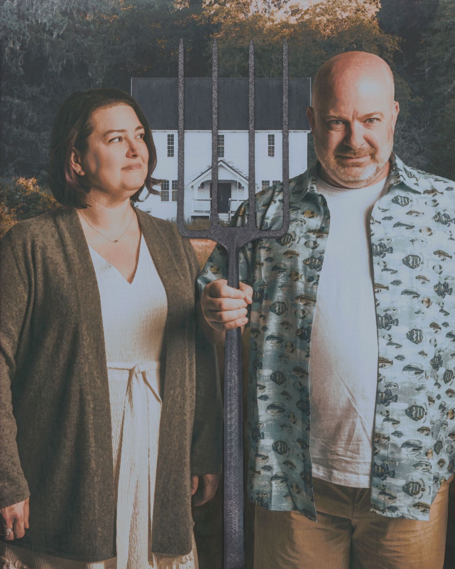 Two people standing in front of a rustic house holding gardening tools.