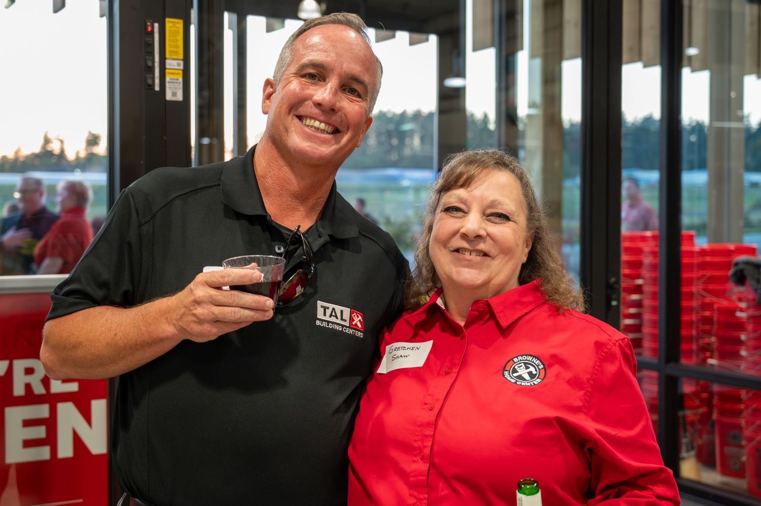 Staff members in branded uniforms at retail store opening celebration.