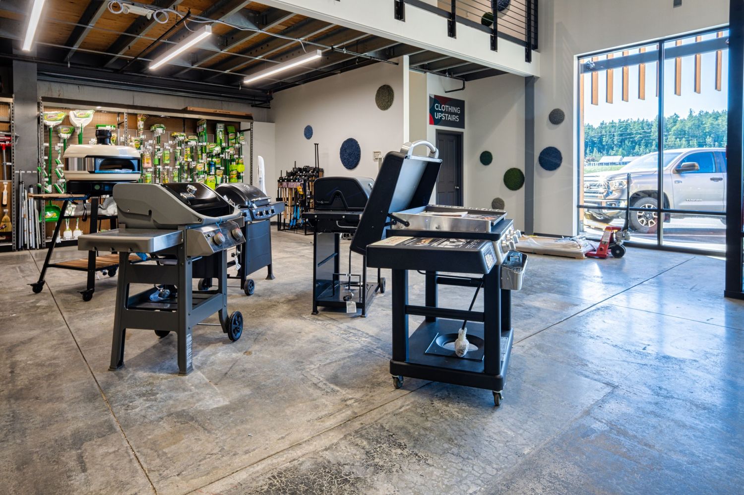 Modern workout space with exercise equipment and large windows.