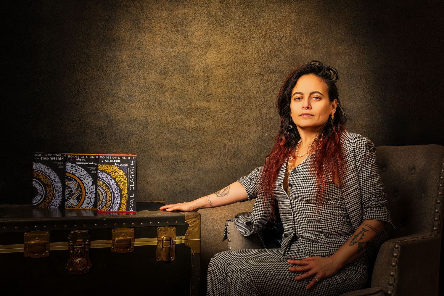 Indoor portrait setting with game boxes and warm dramatic lighting.