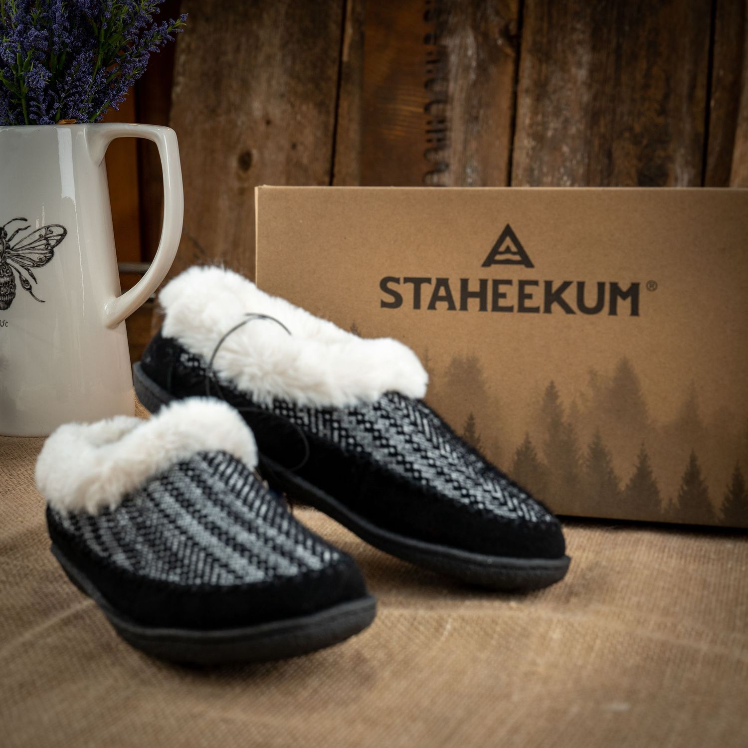 Staheekum slippers with fuzzy lining displayed with butterfly mug and product box.