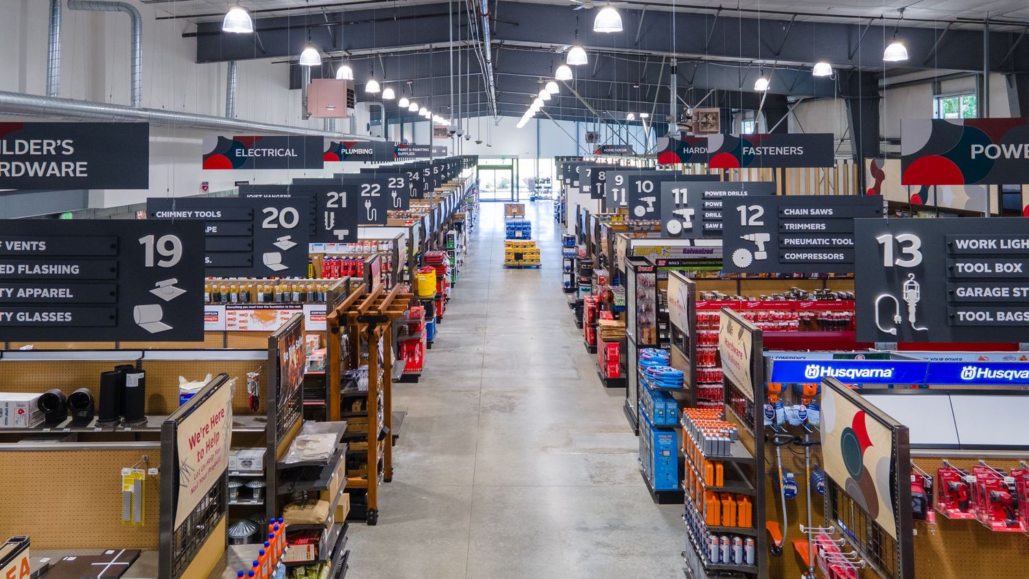 Long retail aisle with numbered sections and organized merchandise displays.