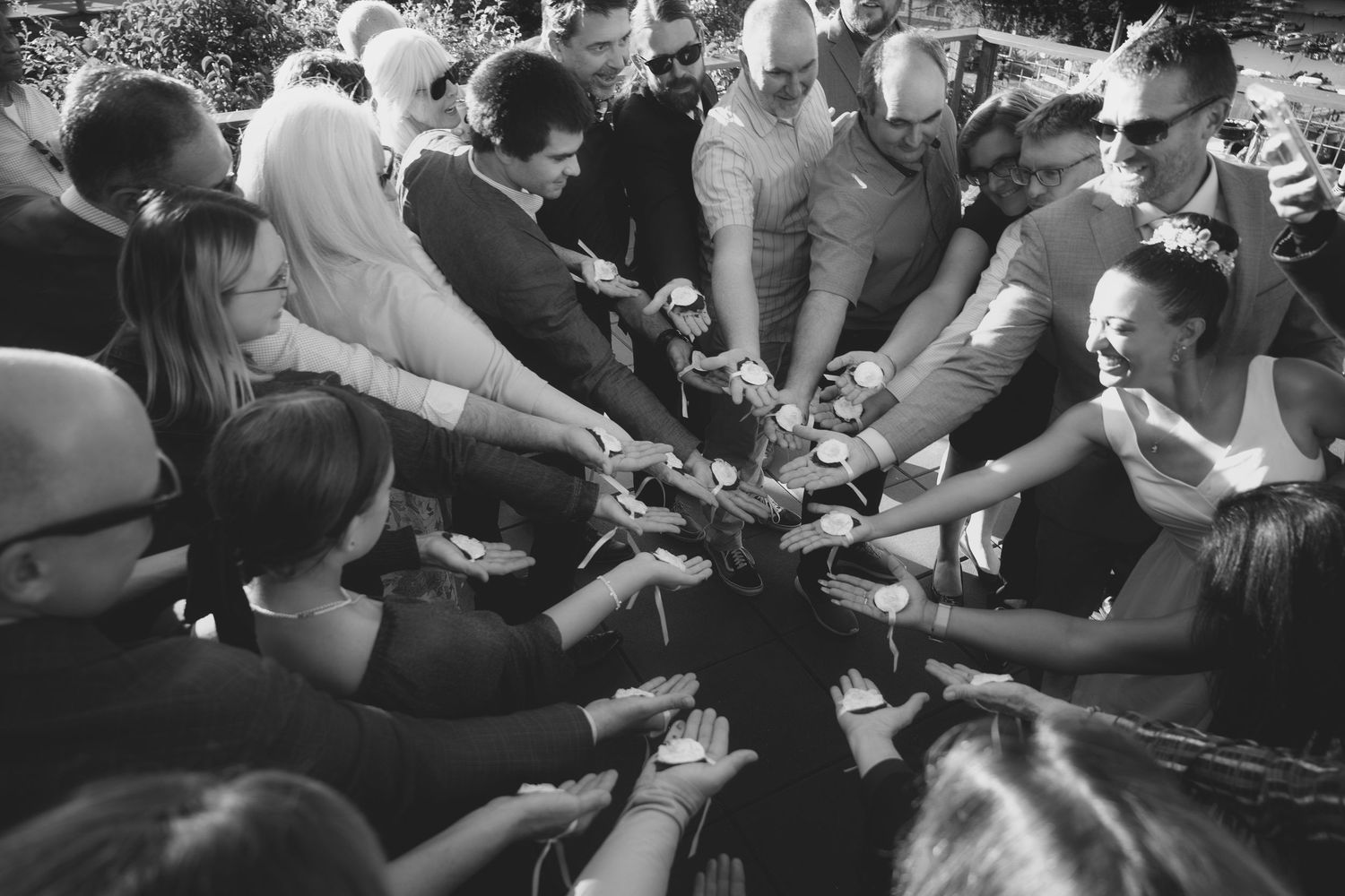 Group of friends joining hands together in a circle showing unity and team spirit.