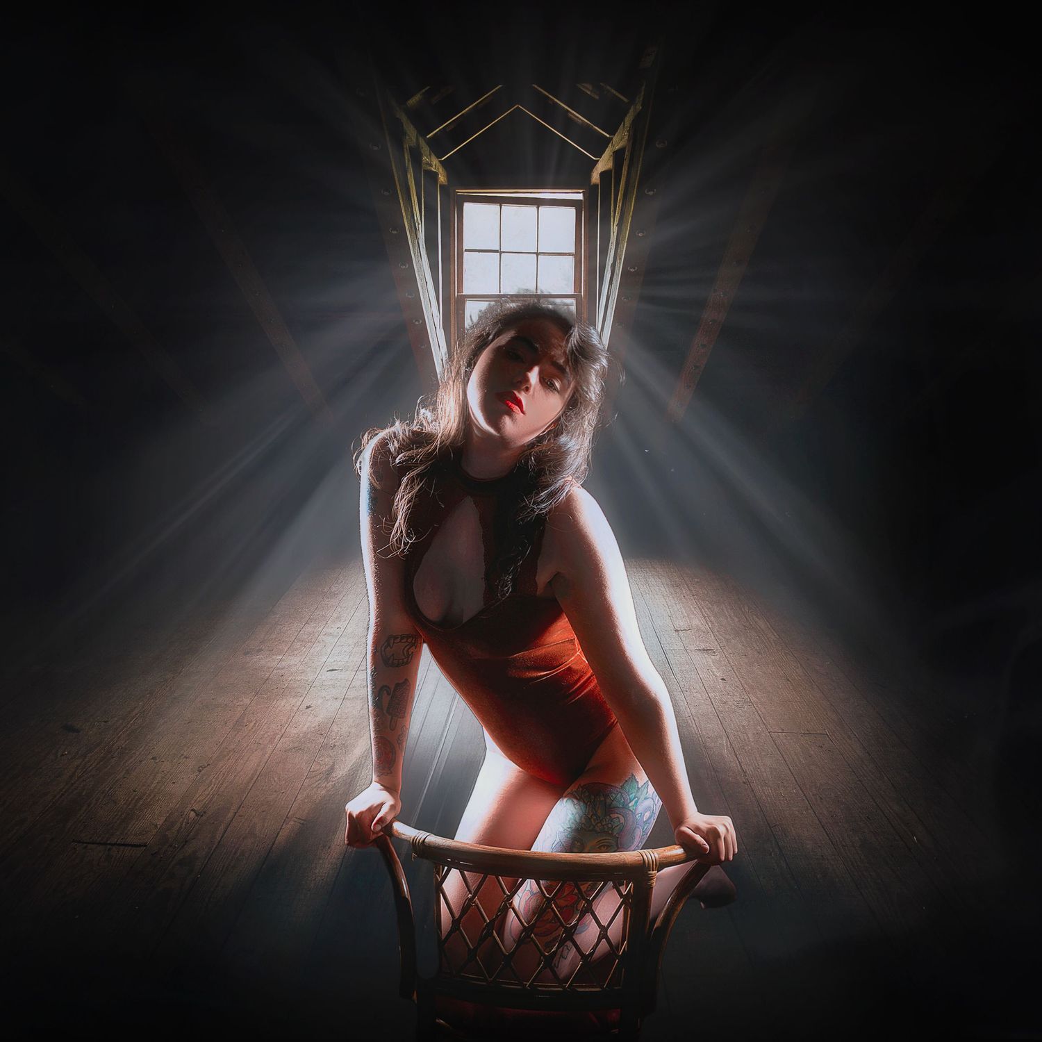 Dramatic silhouette photo with light beams streaming through a window behind the subject.