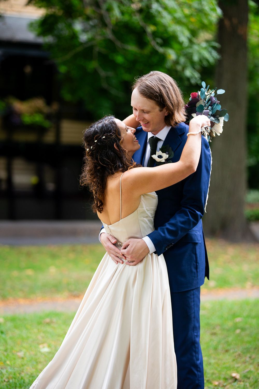 A romantic outdoor wedding moment captured in a garden setting.
