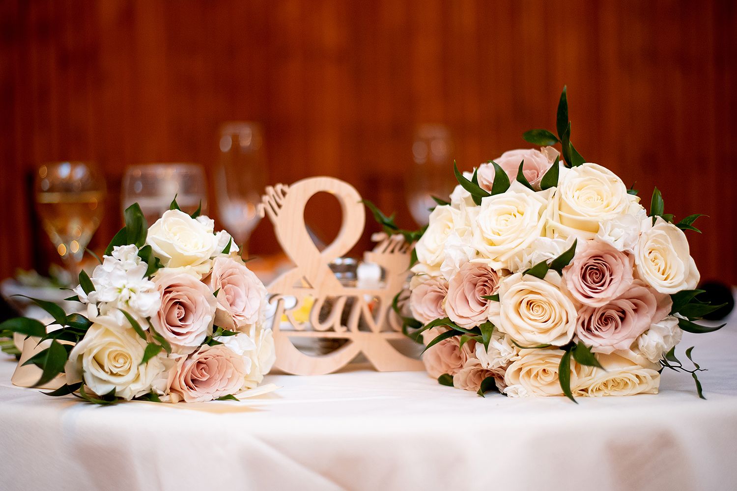Pink and cream roses arranged in an elegant floral garland for wedding decoration.