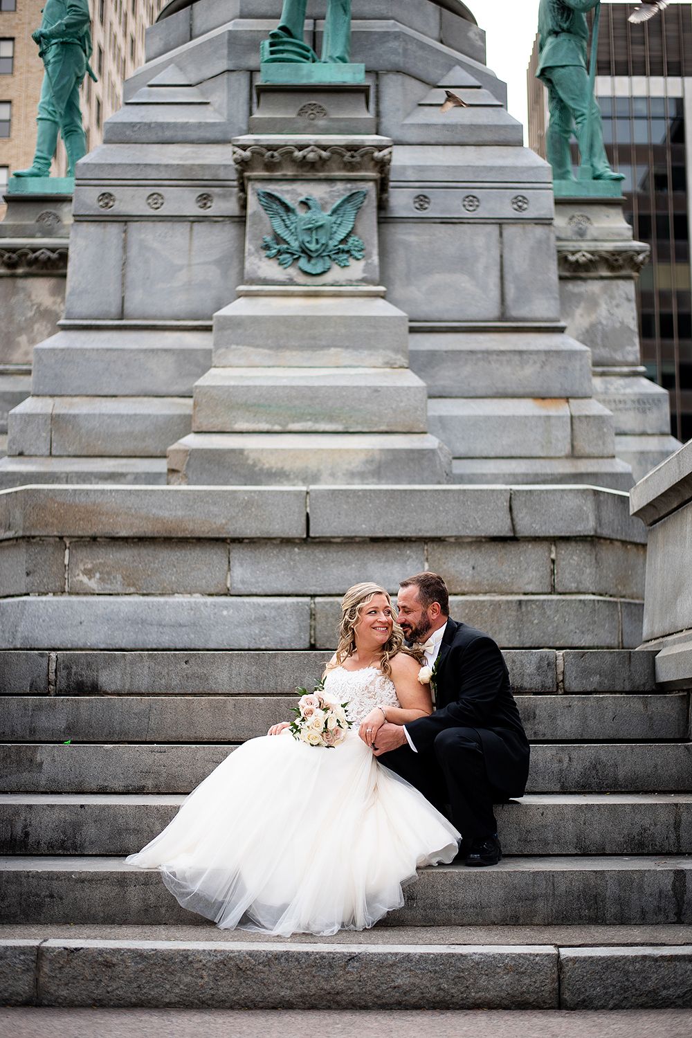 A series of wedding photos showing a couple kissing on stone steps with decorative architectural details in the background.