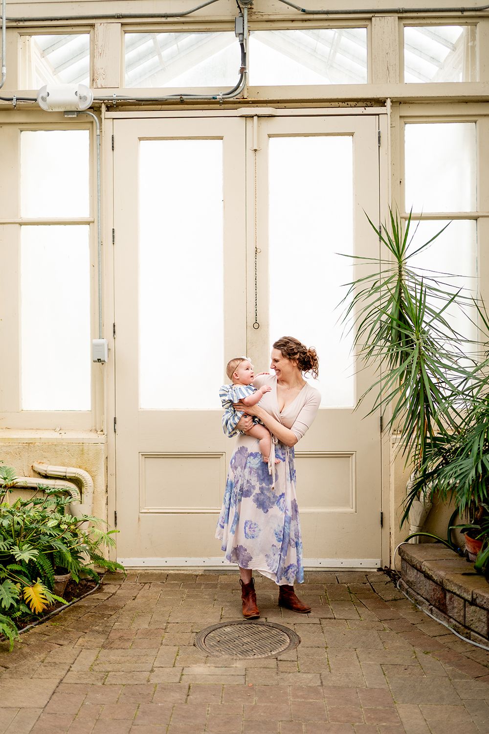 Sequential photos showing joyful dancing and twirling in a sunlit greenhouse with potted plants.