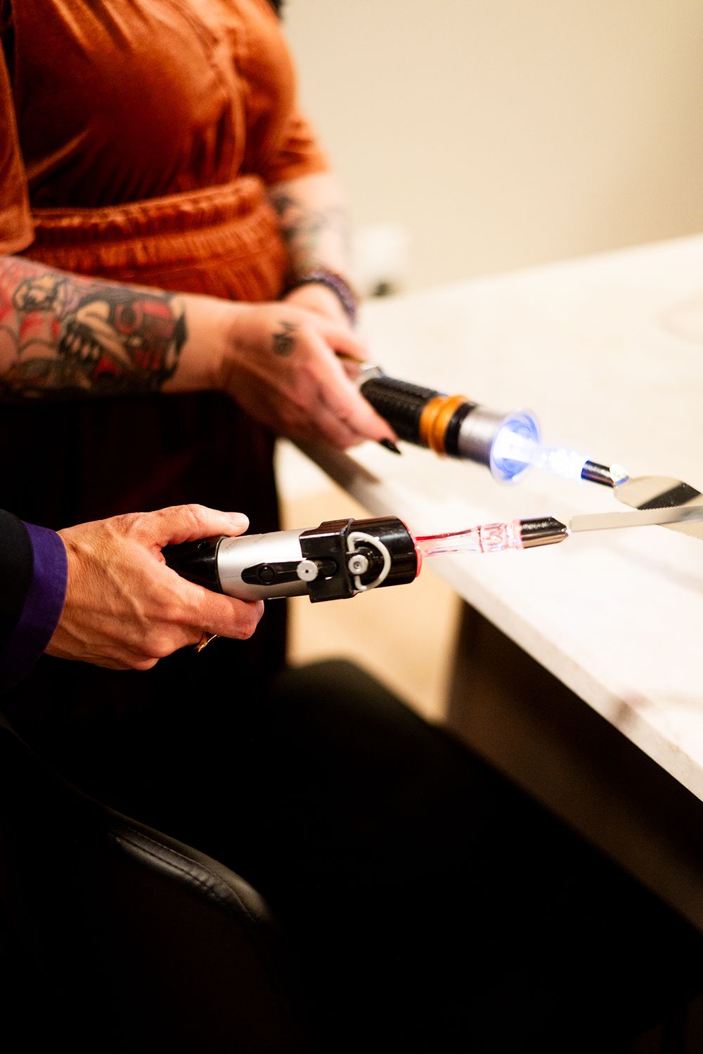 Hands installing baseboard trim using a nail gun in a series of close-up action shots against a white wall.