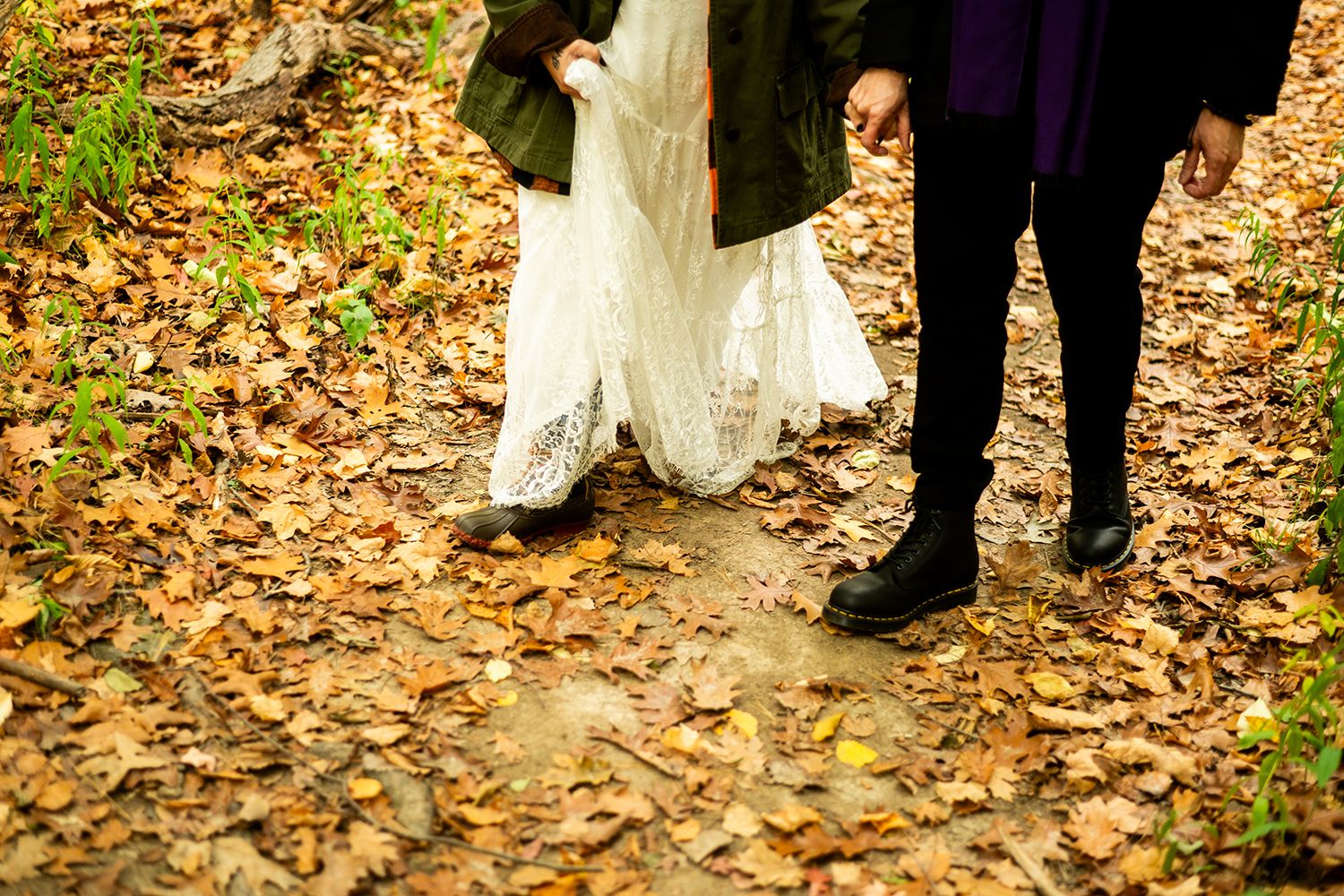 Beautiful wedding couple shares an intimate dance pose surrounded by fall foliage.