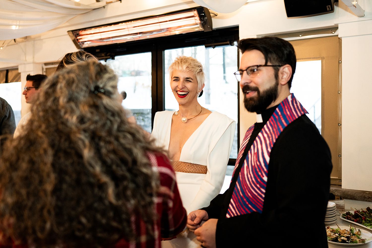 Group engaged in lively conversation at an indoor social event.