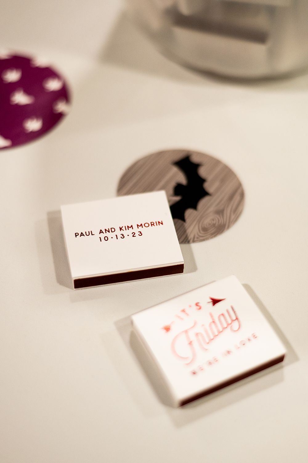 Close-up view of minimalist place cards with elegant typography and soft shadows against a white surface.