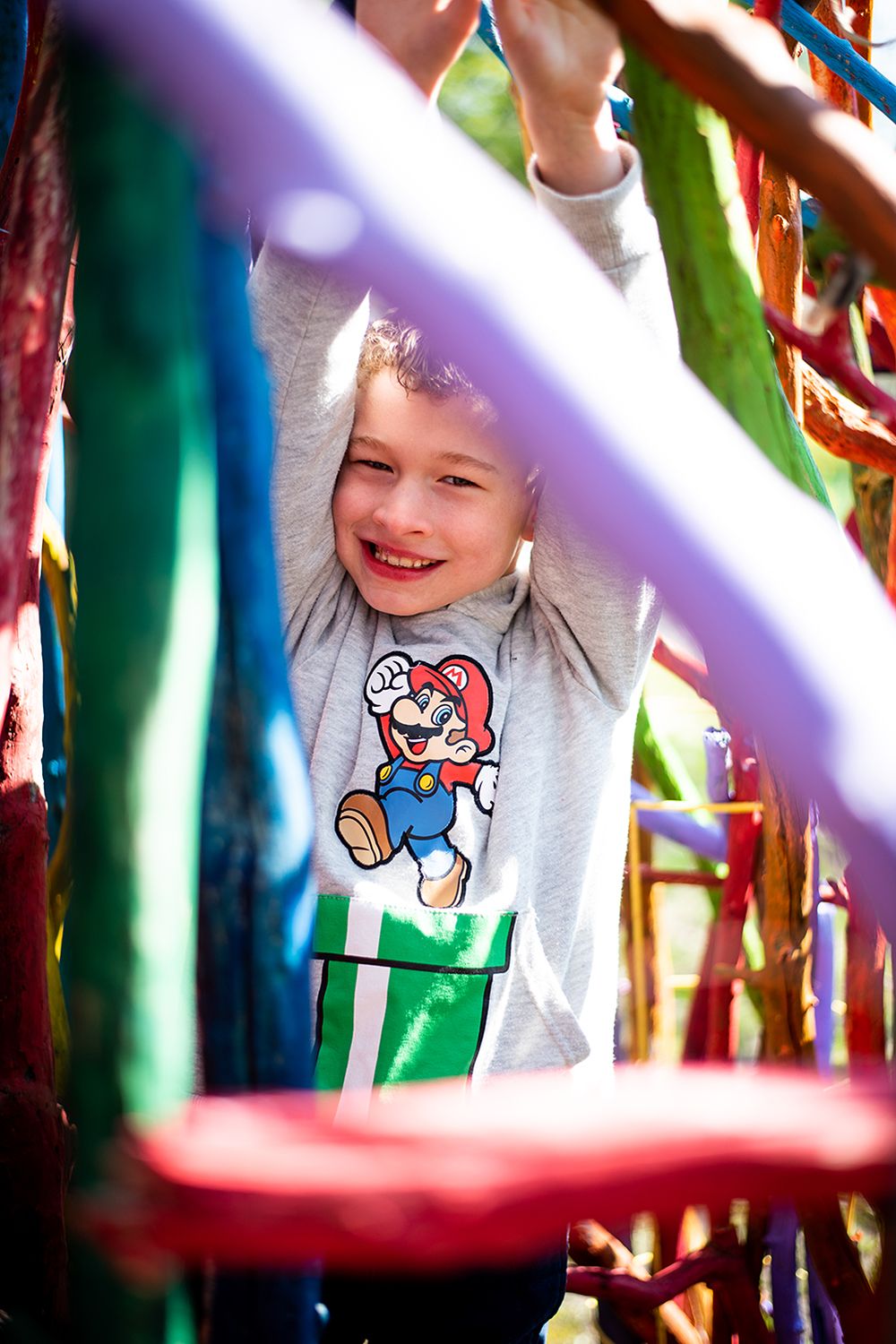 Joyful moment captured through colorful stripes showing a Super Mario character sweater.