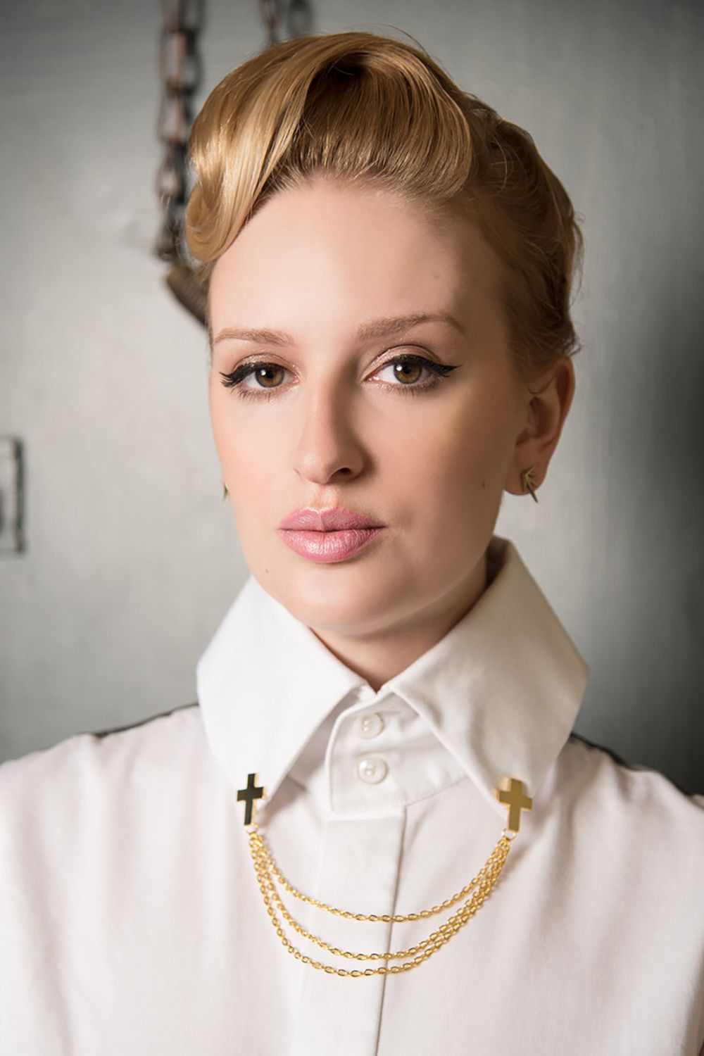 A series of close-up portraits showing details of a white high-collared blouse adorned with a delicate gold chain necklace.