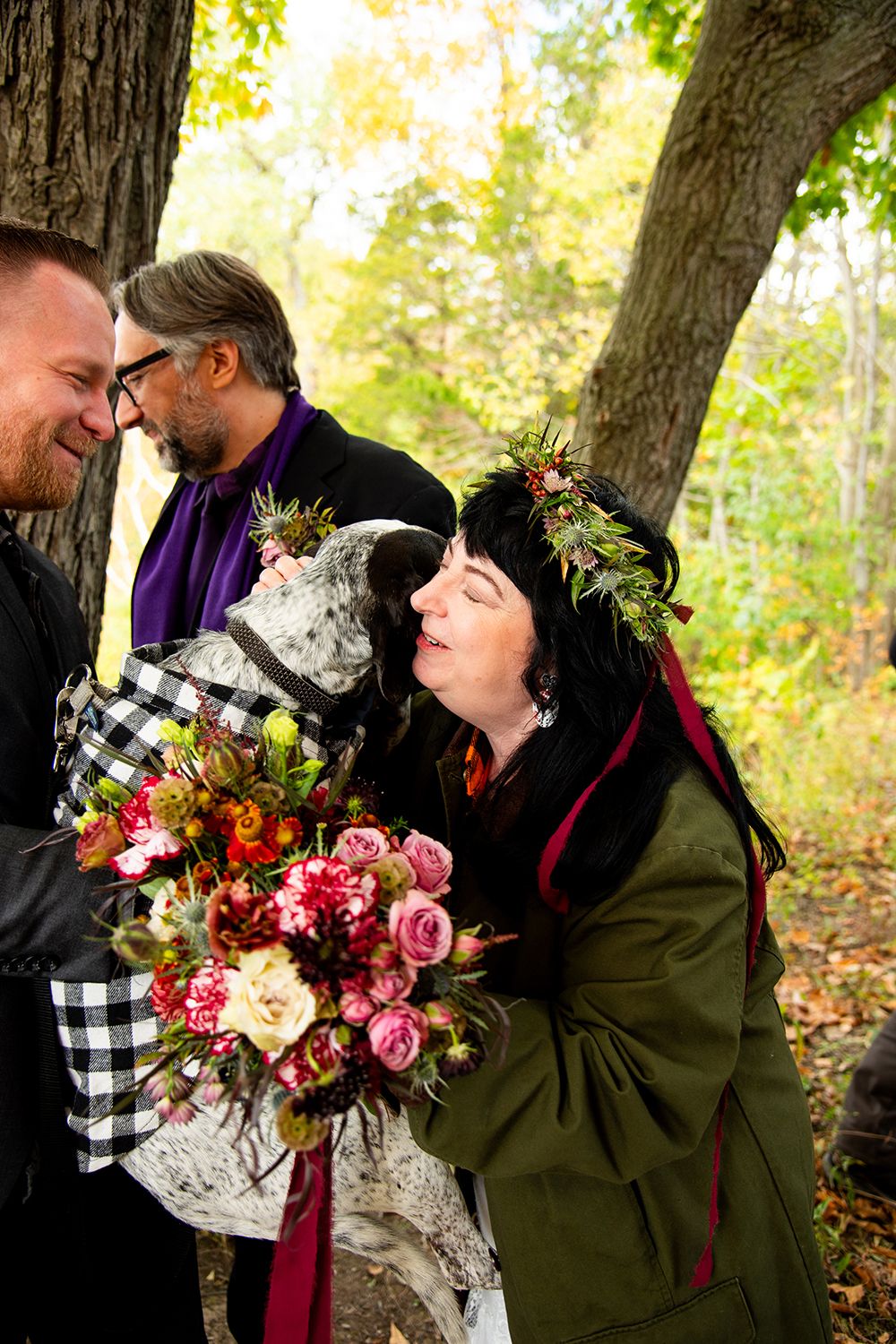 A joyful moment during a fall wedding ceremony with a beautiful floral bouquet and autumn decor.