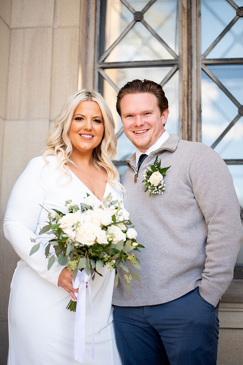 A series of wedding photos showing a couple in gray and white posing in front of a decorative window.