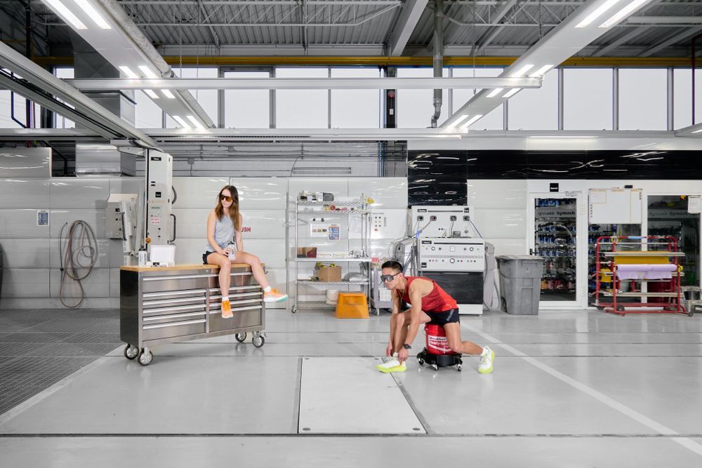 A man & women is seated on the floor in front of a bright red storage unit, appearing calm and comfortable in his surroundings.