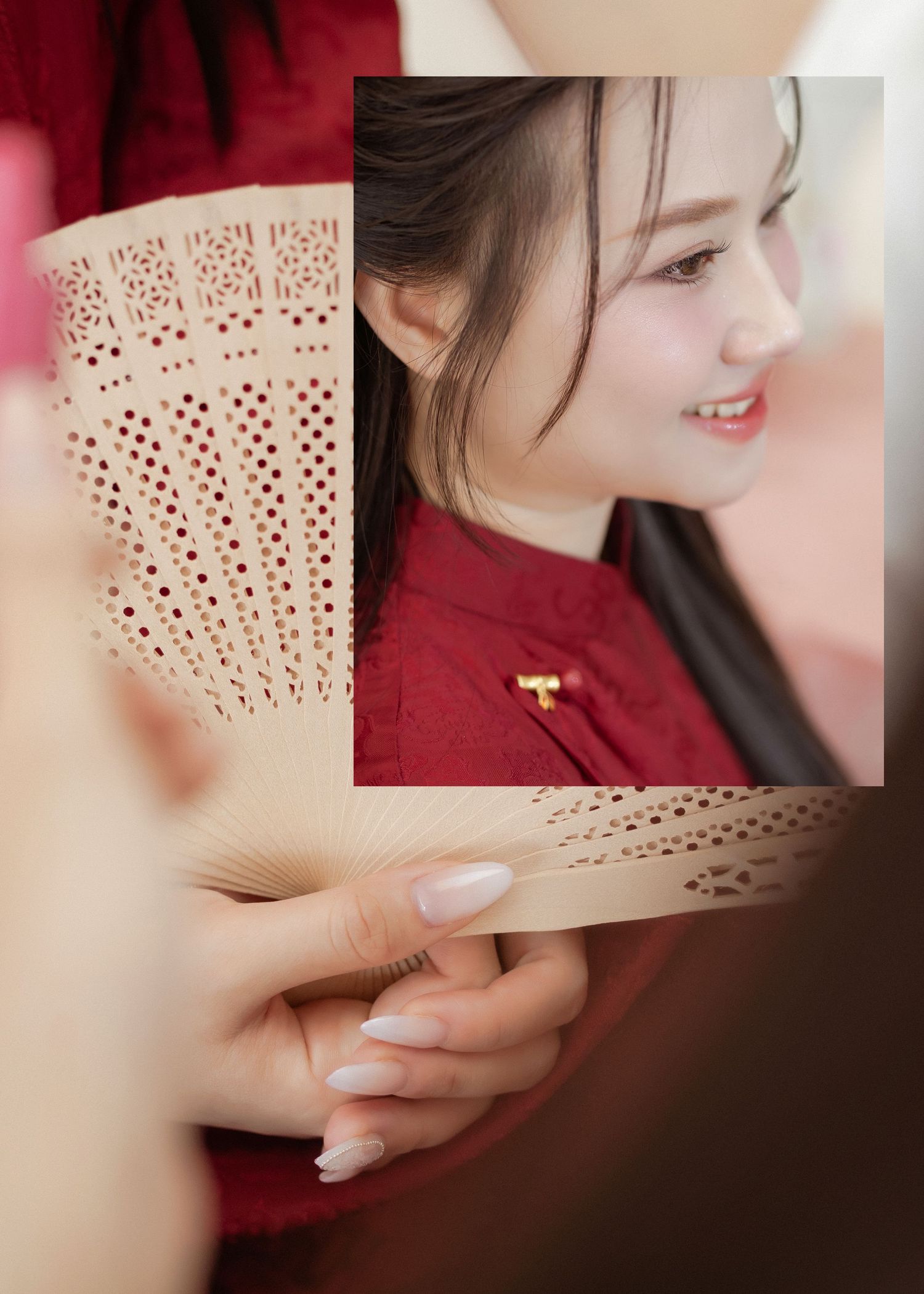 Traditional ornate paper fans displayed next to someone wearing a red cheongsam dress with embellished details.