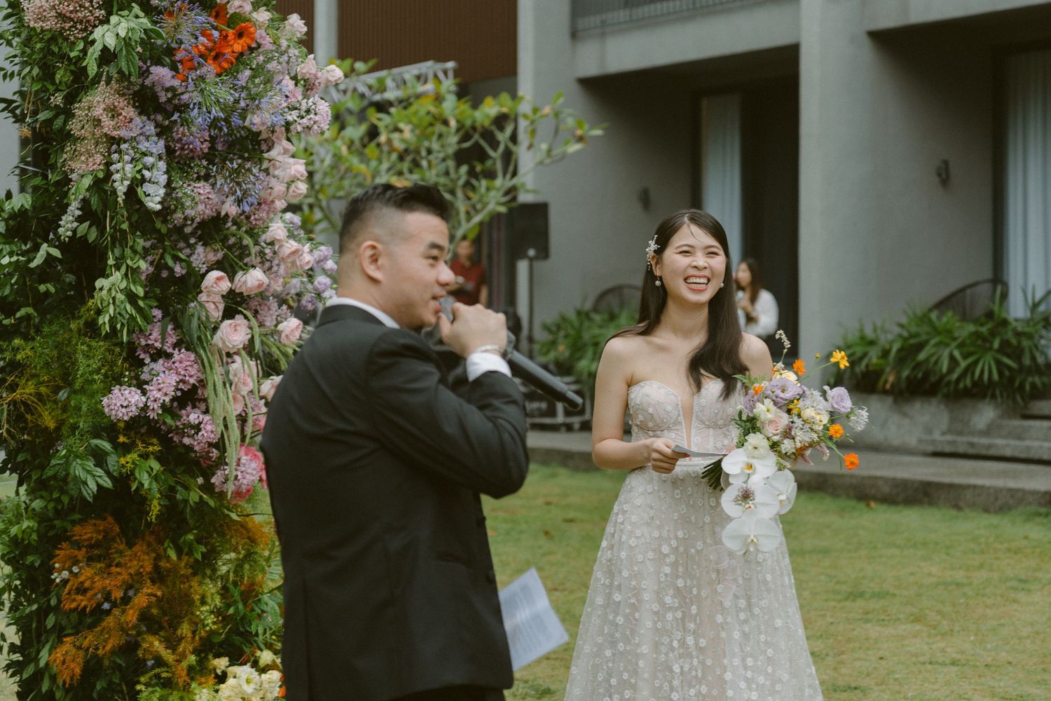 A romantic outdoor garden wedding ceremony features elegant floral arrangements and decor in a lush natural setting.
