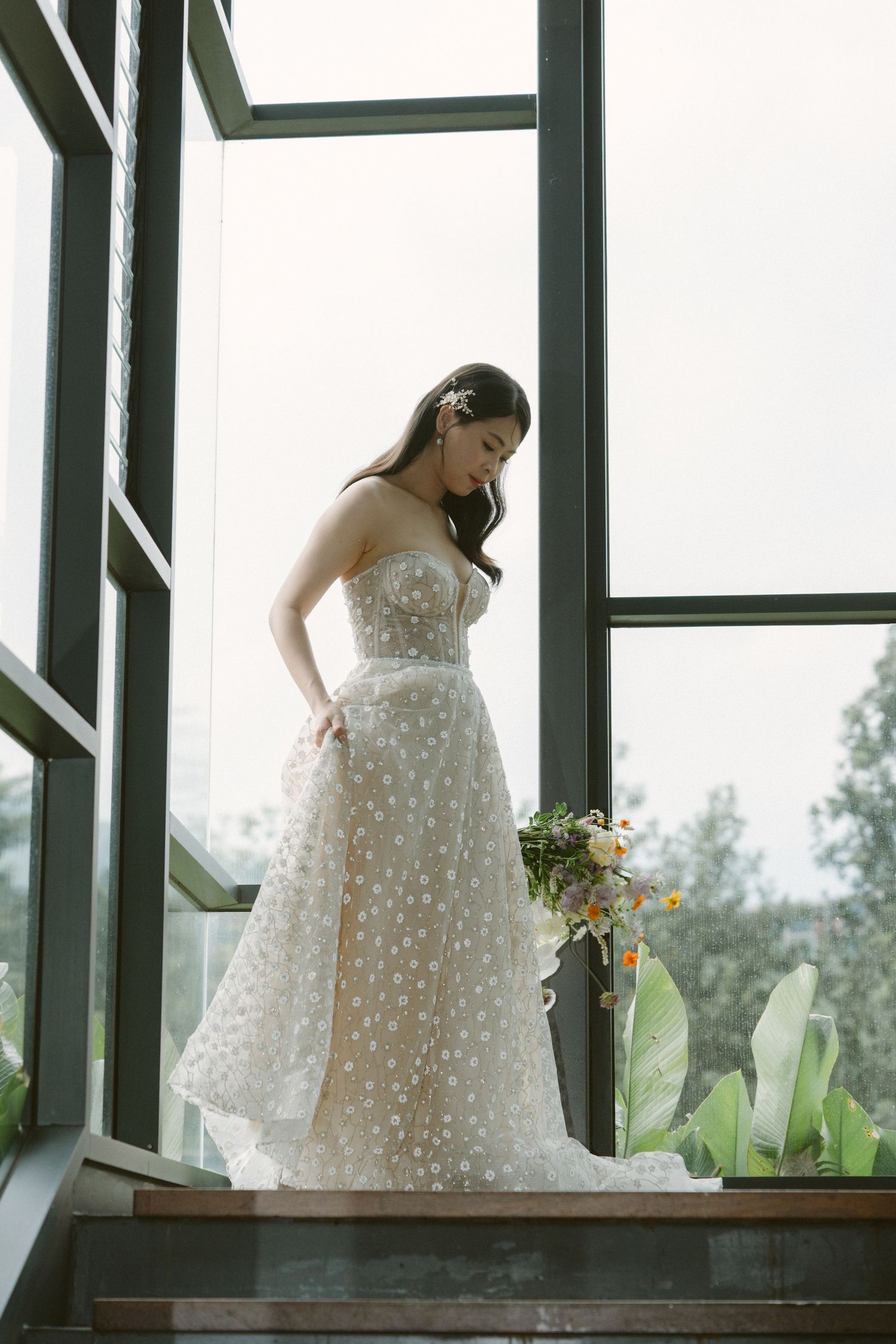 Ethereal wedding dress with delicate polka dot tulle fabric shown in multiple angles against bright window light.