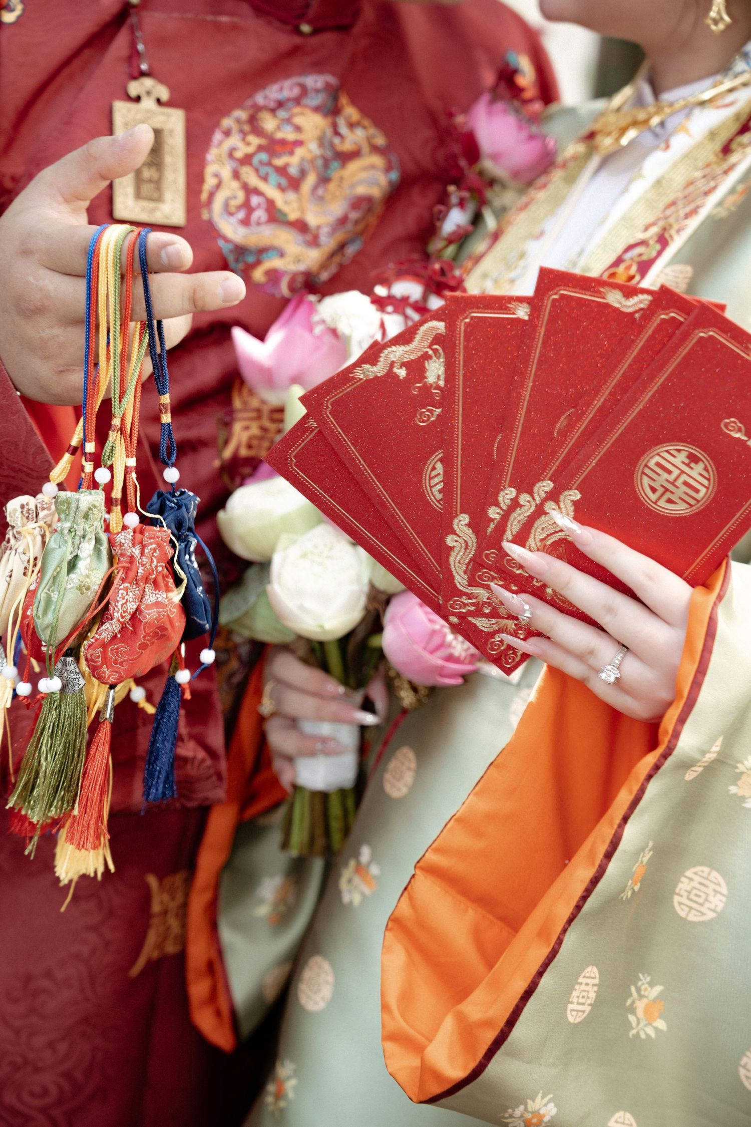 Traditional red and gold lunar new year decorations with red money envelopes and colorful tassels shown in detail.