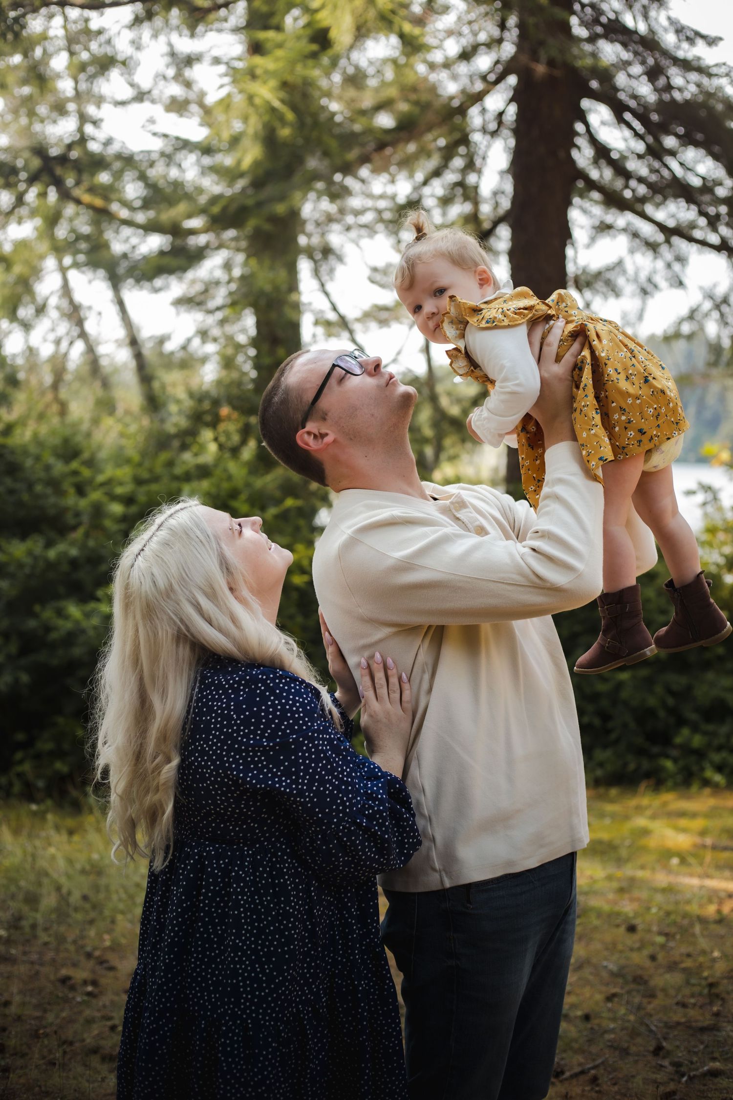 A joyful family moment captured outdoors among trees.