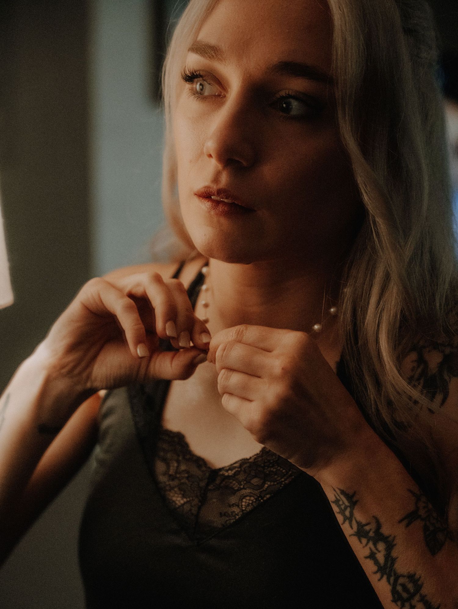 Artistic portrait series in moody lighting showcasing feminine beauty with delicate poses and vintage aesthetic.