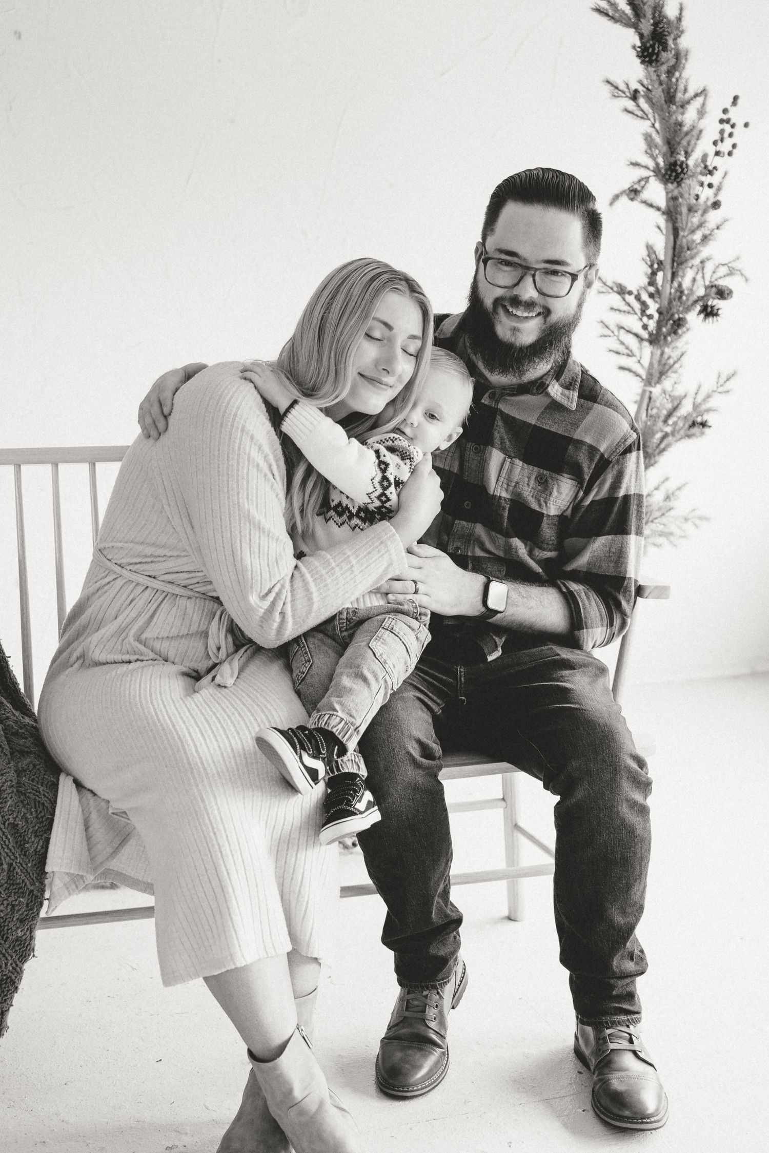 A family embrace during a Christmas photography session with their one year old