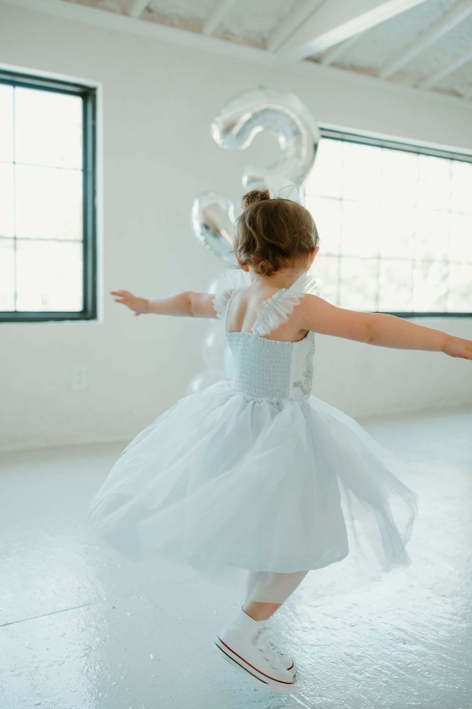 A 3 year old twins in her princess dress for her birthday photoshoot