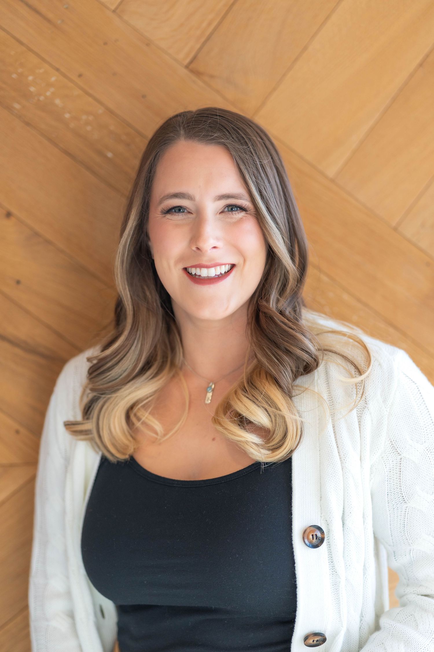girl wearing a white cardigan and black shirt.
