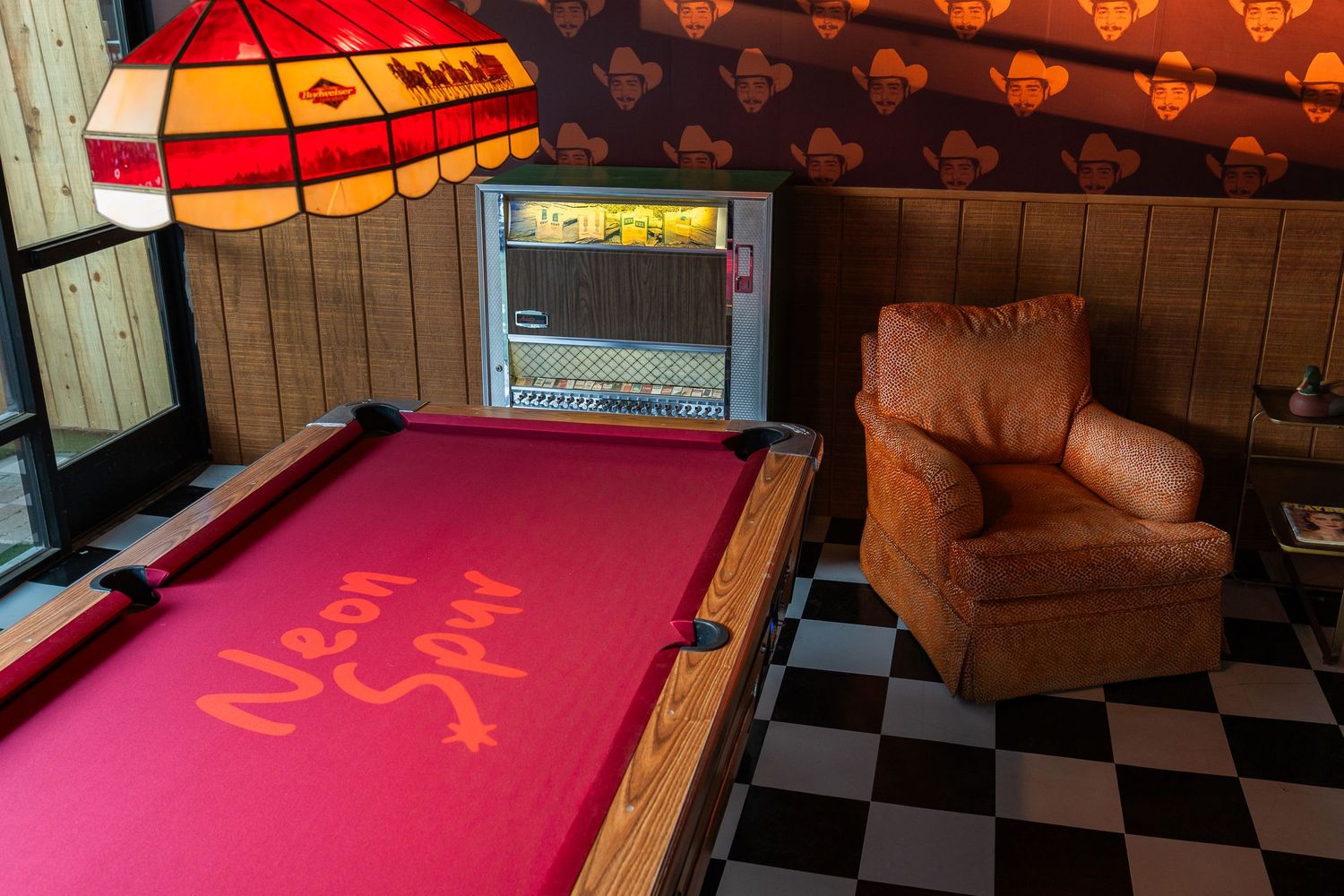 pool table with a juke box and post Malone wall paper