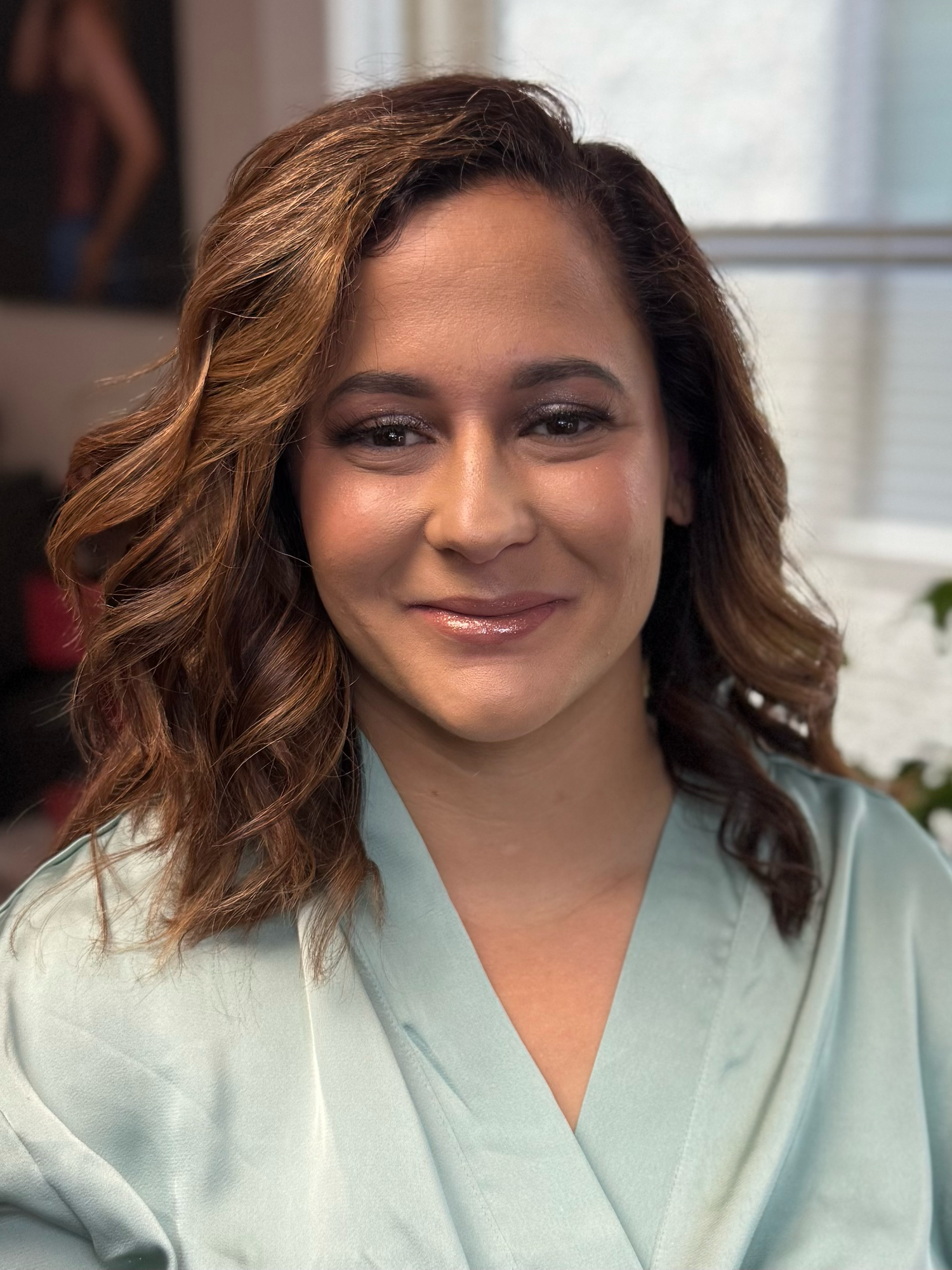 A Before and After photo series of a person wearing a mint green robe smiles warmly while posing for a sequence of close-up headshots.