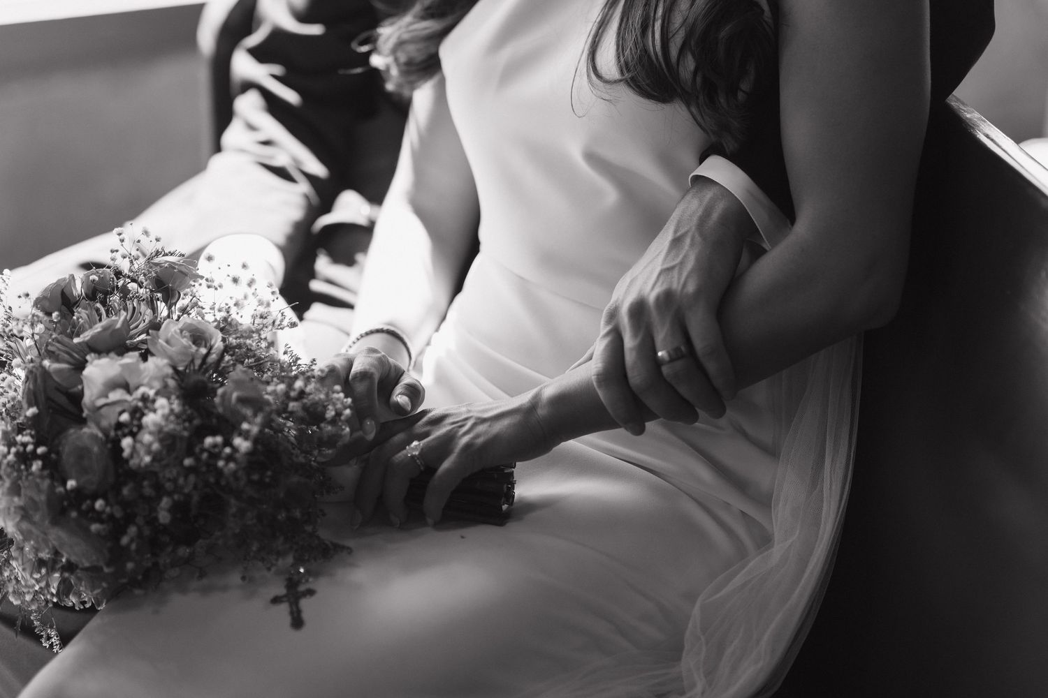 A black and white wedding photo collage showing various romantic moments between the newlyweds.