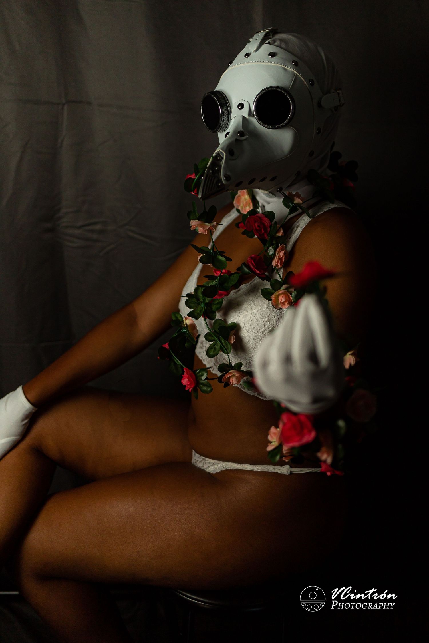 A series of five artful boudoir portraits featuring roses and a white theatrical mask against dark background.