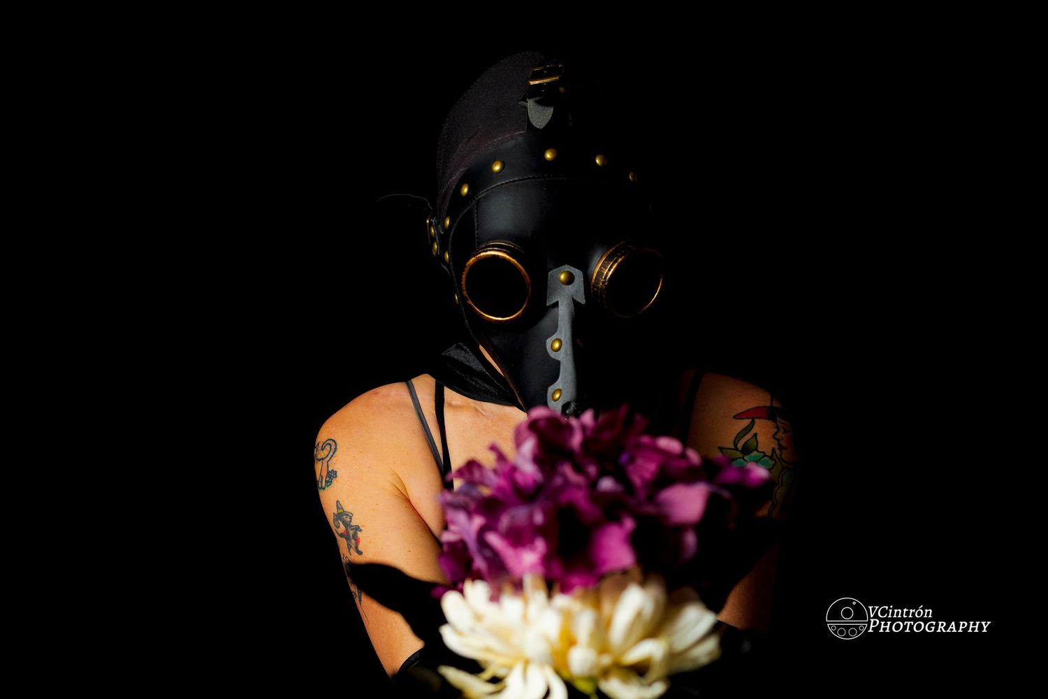 Artistic black and white side profiles adorned with vibrant purple and white orchid flowers against dark background.