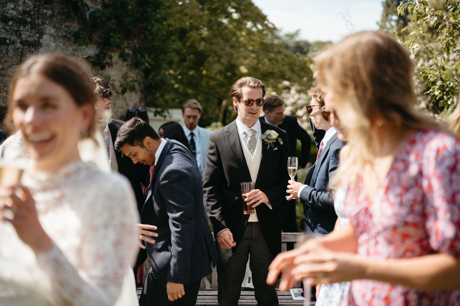 Wedding guests mingle and celebrate during an outdoor reception.