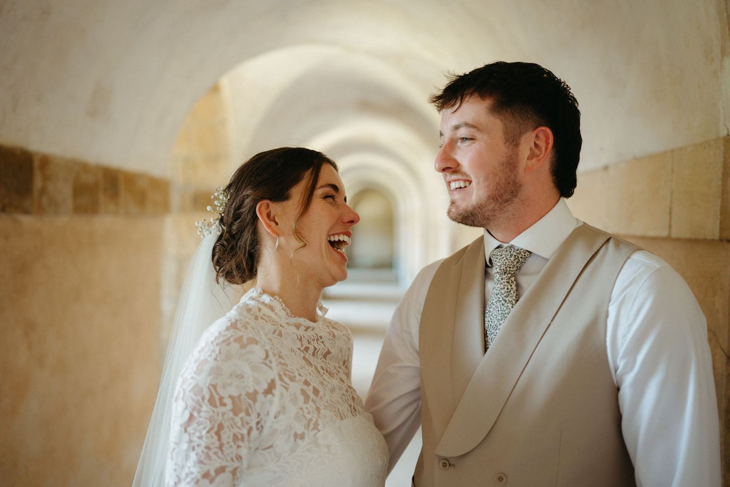 A romantic wedding moment captured between a couple in an intimate indoor setting.