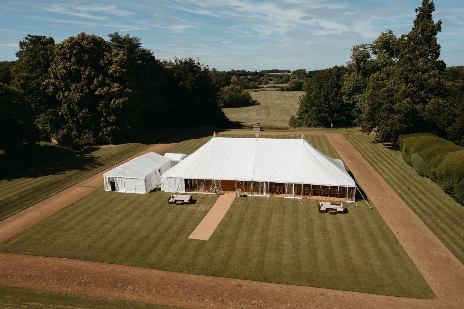 Sweeping view of well-maintained cricket grounds and sports fields next to historic buildings.
