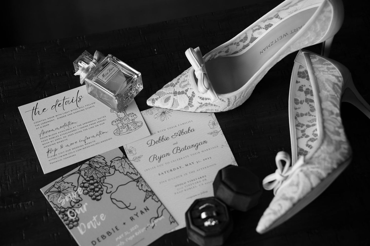 Wedding details including invitations and bridal shoes in black and white.