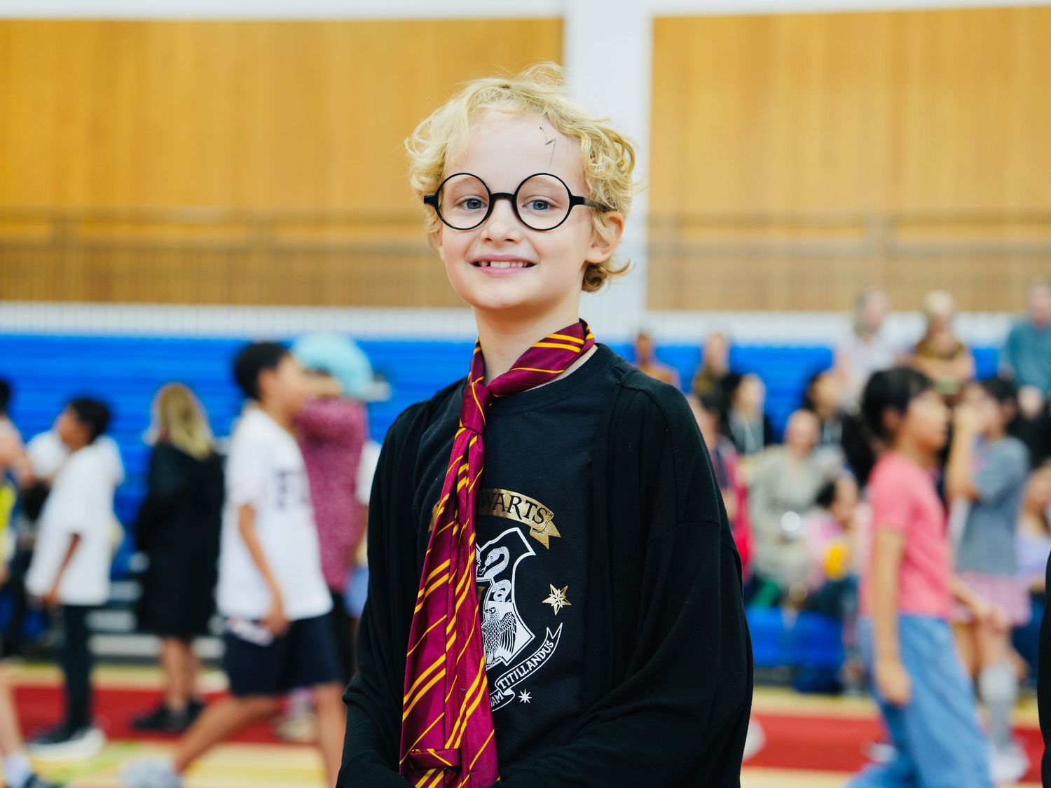 Students dressed in Harry Potter themed costumes participate in a school performance.