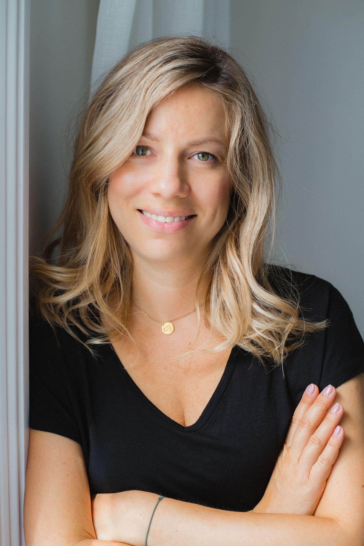 Lifestyle portrait sequence showing natural expressions and black v-neck top.