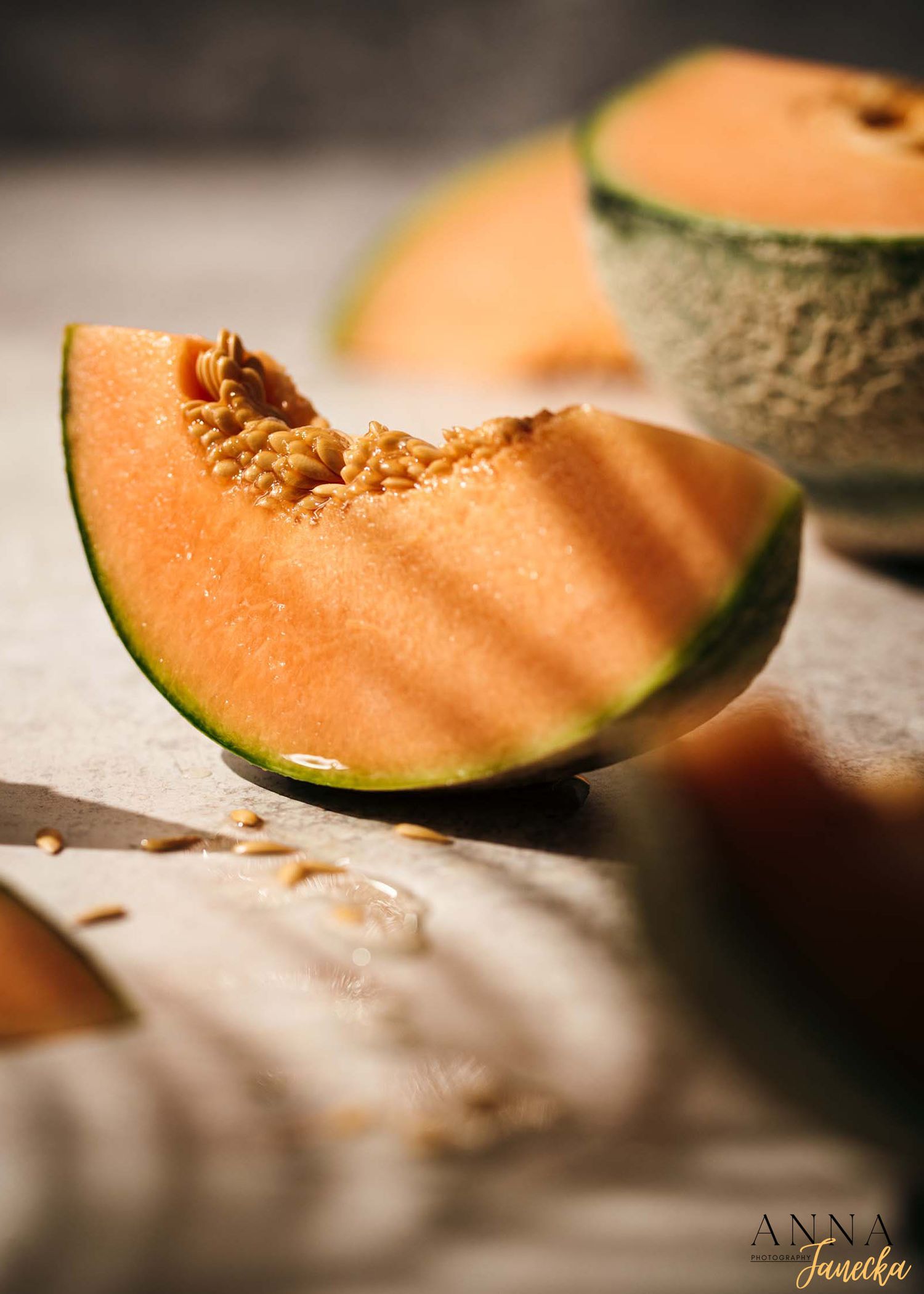 Close-up shot of fresh cantaloupe slices with soft focus lighting.