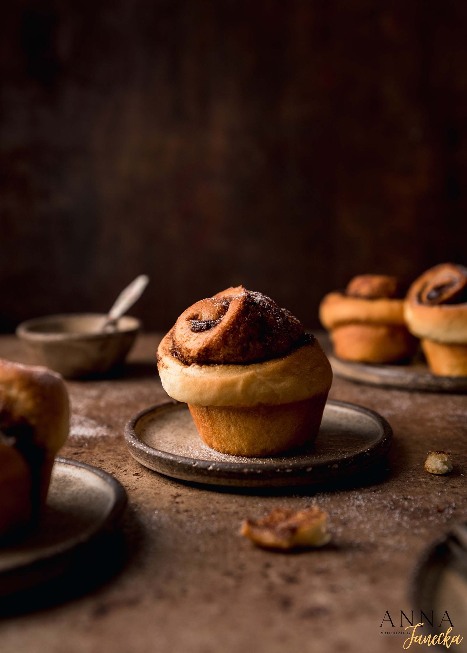 Chocolate filled pastries displayed on individual plates with moody dark lighting.