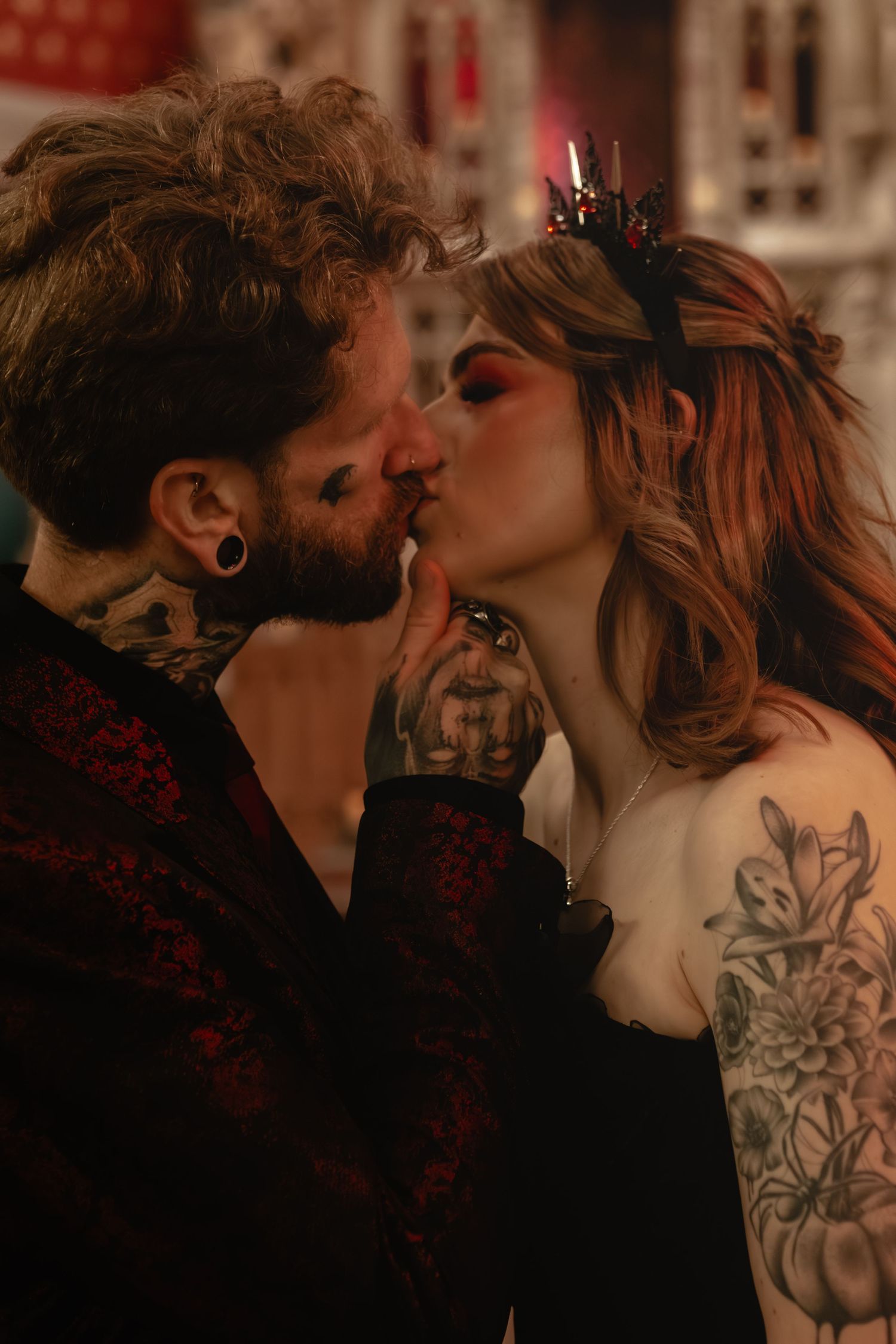 Alternative wedding couple sharing intimate kiss in gothic church setting.