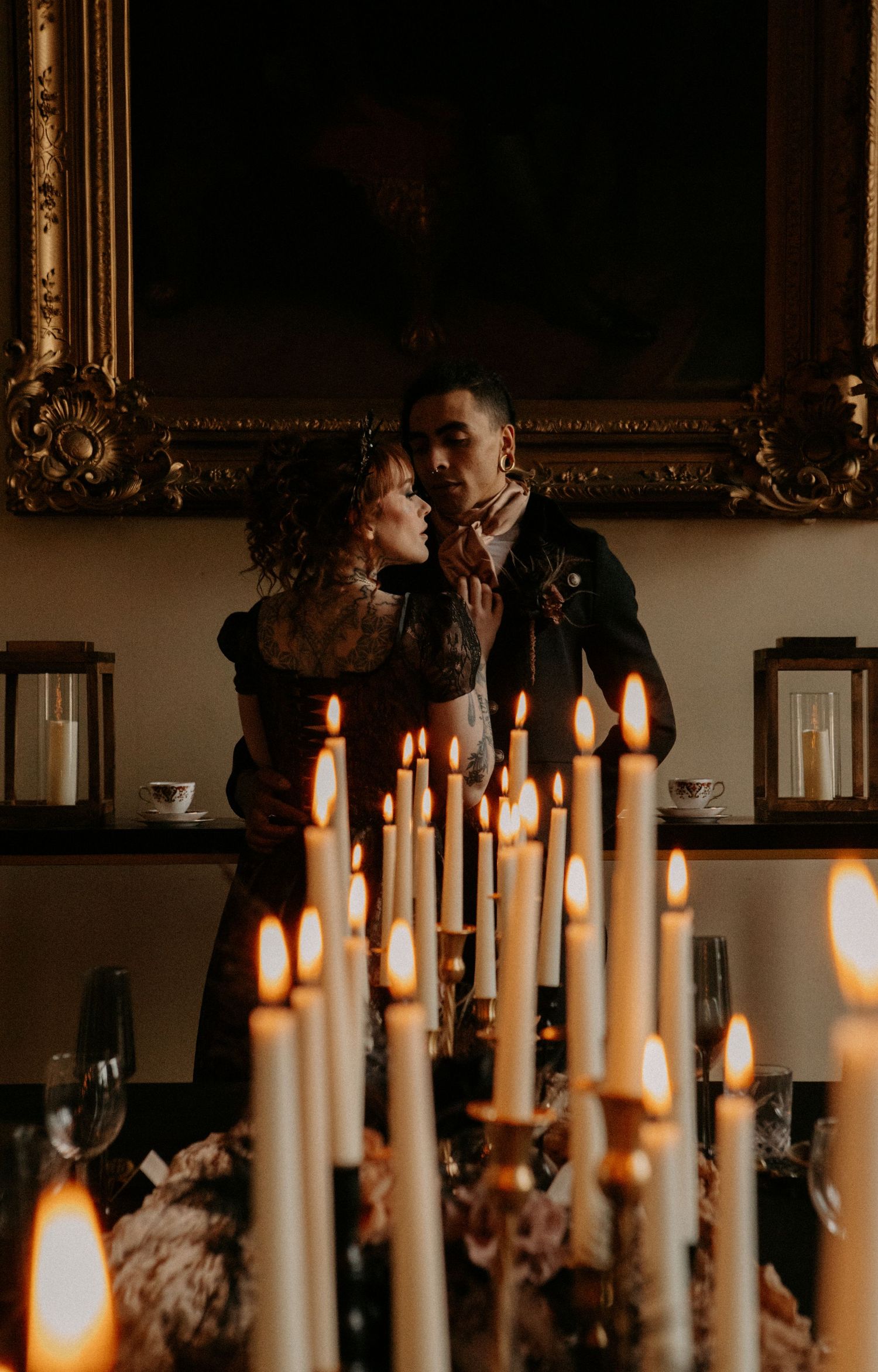 A romantic candlelit scene with multiple white candles in gold frames.