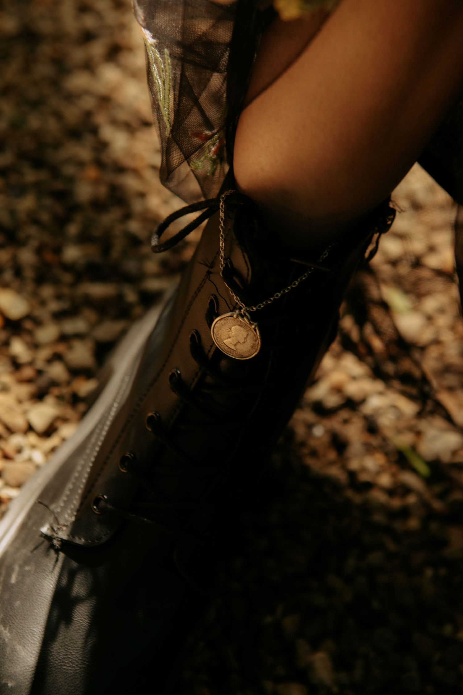 Close-up shot of a Sig Sauer handgun's slide and trigger mechanism in dramatic low-key lighting.
